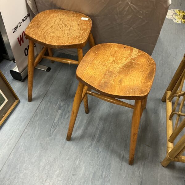 Pair of vintage wooden stools with rustic charm.