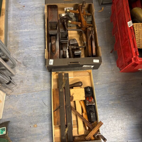 Vintage woodworking tools lot including planes and chisels.