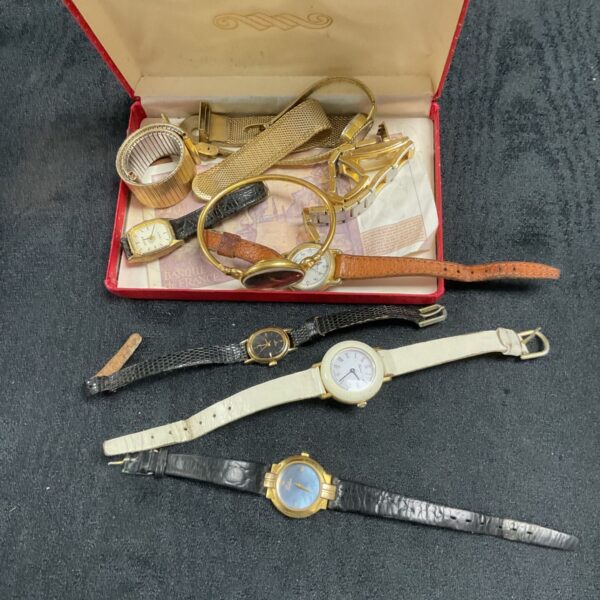 Tray of assorted vintage wristwatches, collectible timepieces on display.
