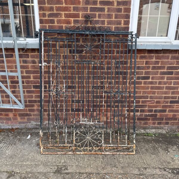 Ornate vintage wrought iron gates with floral detailing.