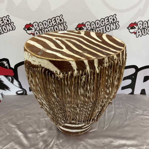 Vintage zebra hide bongo drum, African tribal percussion instrument.