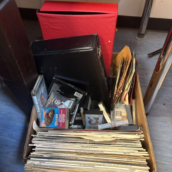 Mixed lot of vintage vinyl records and cassette tapes for collectors.