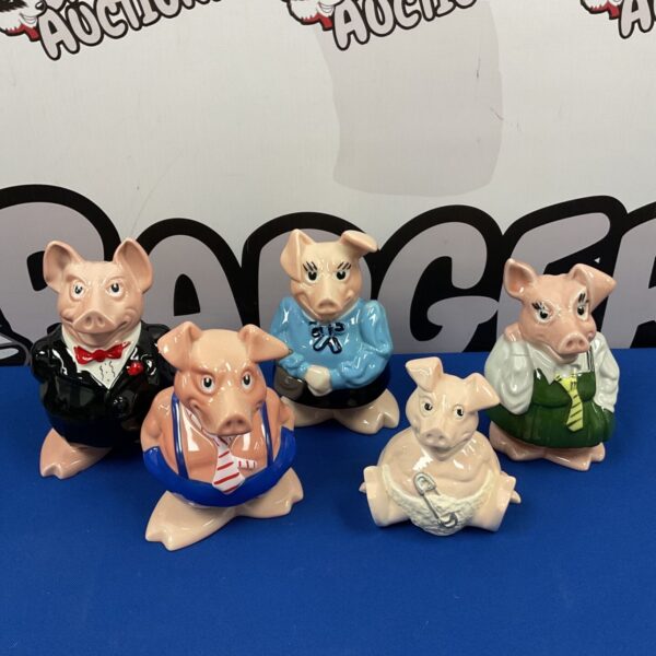 Set of five Wade Natwest ceramic piggy banks in various outfits.