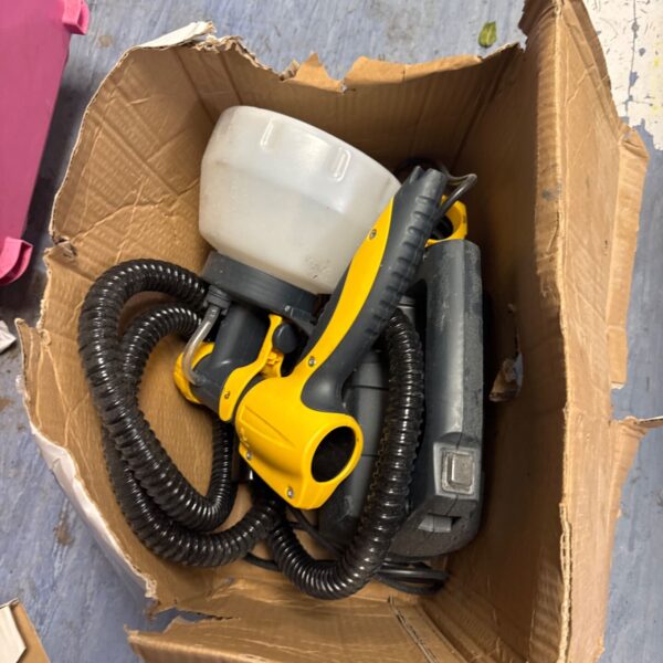 Used Wagner electric paint sprayer with hose and nozzle.