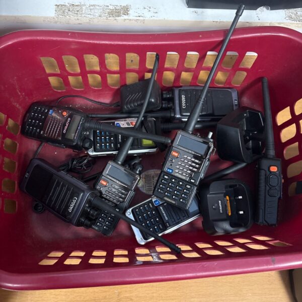 Lot of vintage walkie talkies including a Motorola radio.