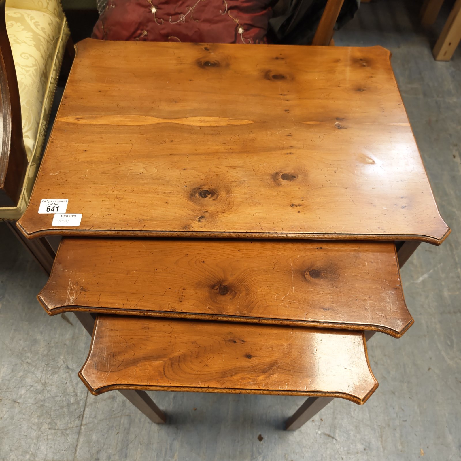 Vintage walnut nest of tables with shaped edges and turned legs.