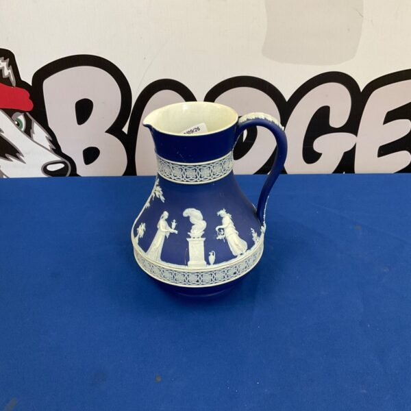 Antique Wedgwood blue and white jasperware jug, detailed transferware design.