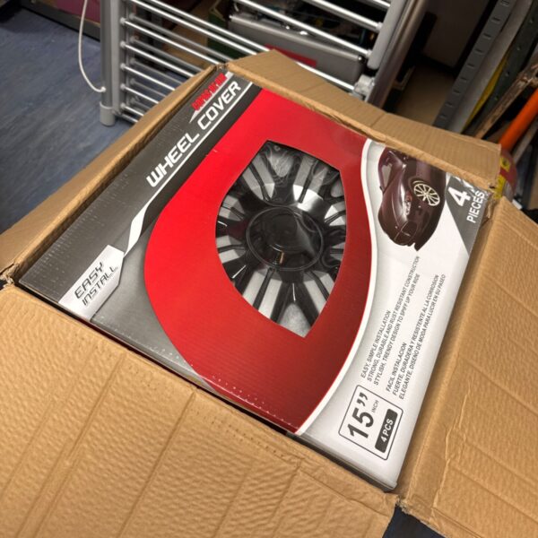 Box of new 15 inch black and silver wheel trims.