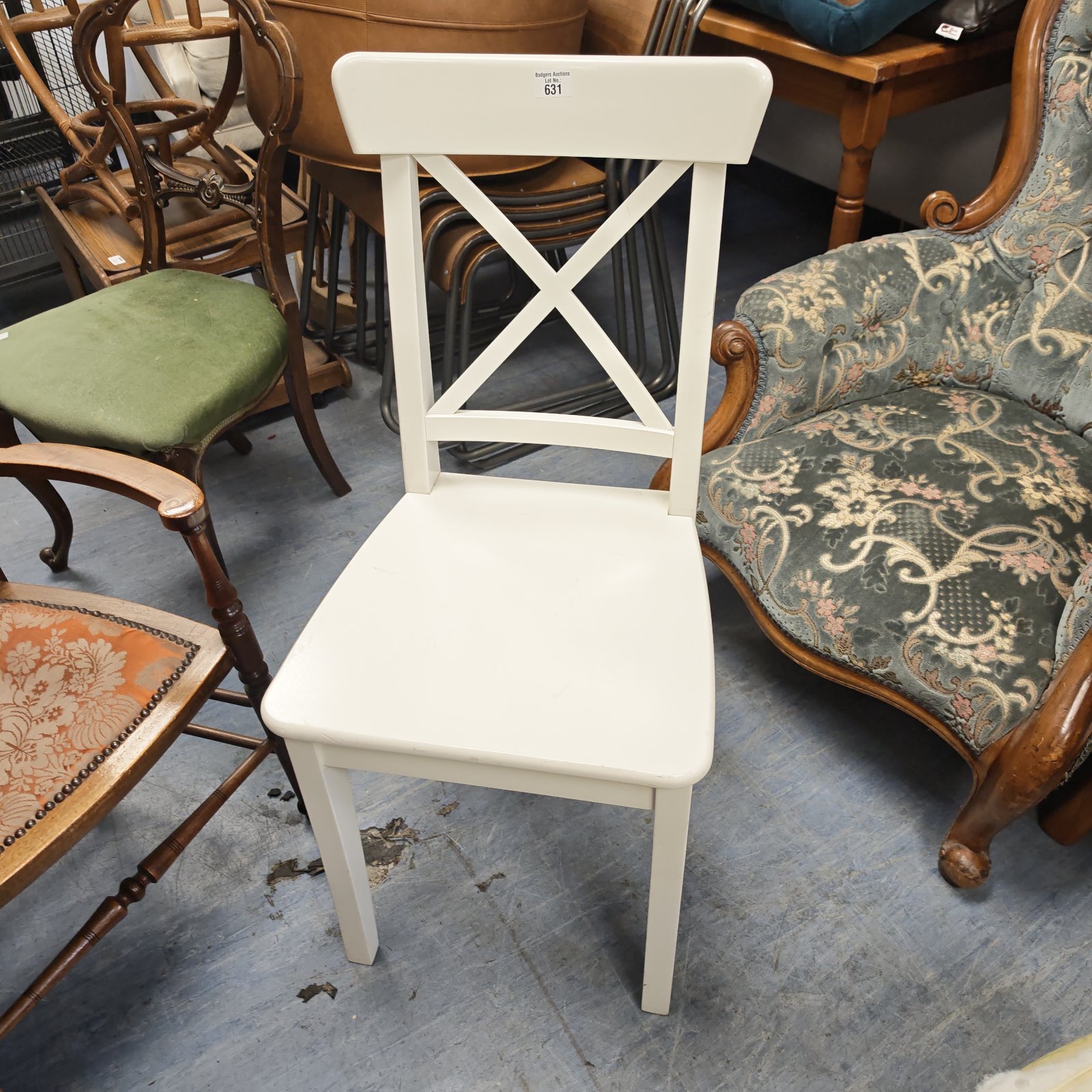 White cross back dining chair with a shaped seat and rustic charm.