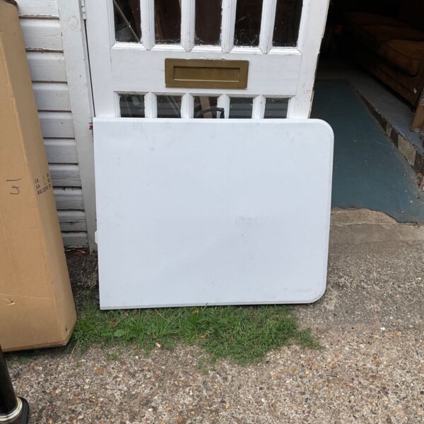 White folding table shown against a doorway, ideal for portable use.