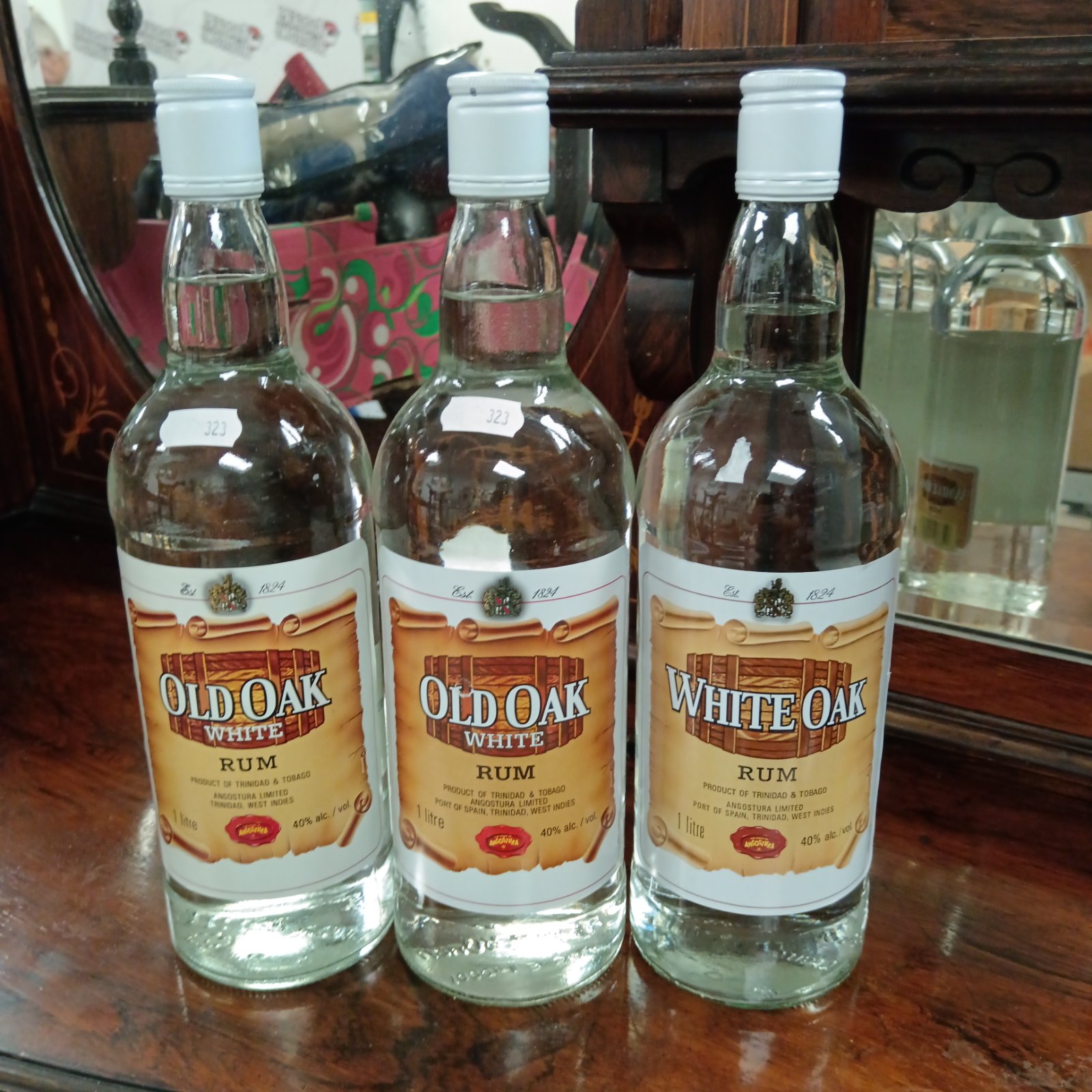 Three sealed bottles of White Oak Rum from Angostura.