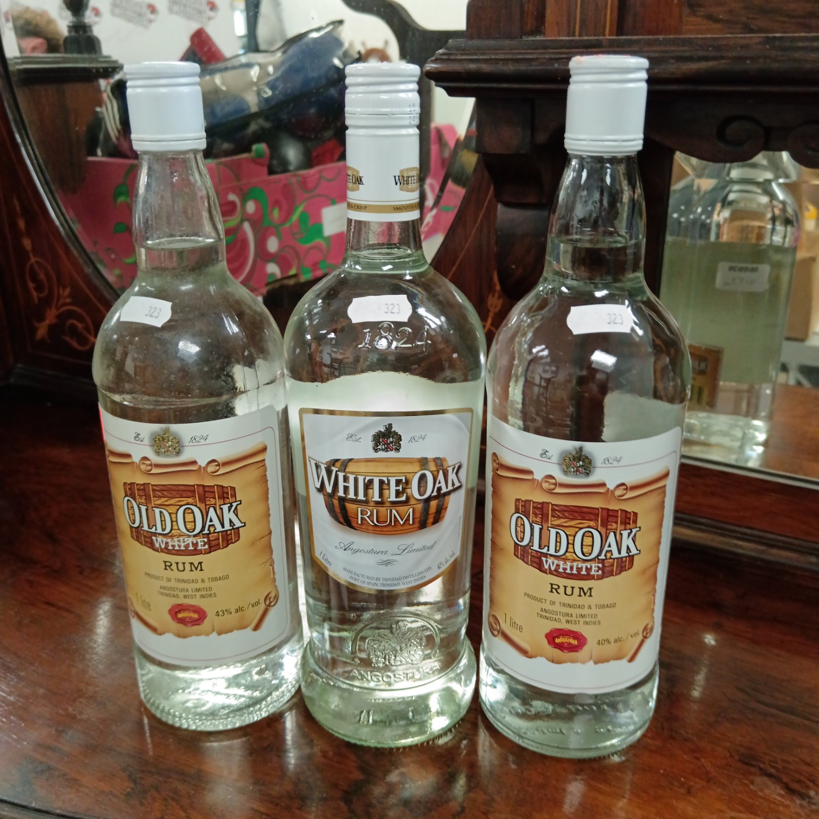 Three sealed bottles of White Oak Rum from Angostura, Trinidad.