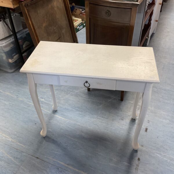 White painted side table with curved legs and single drawer.