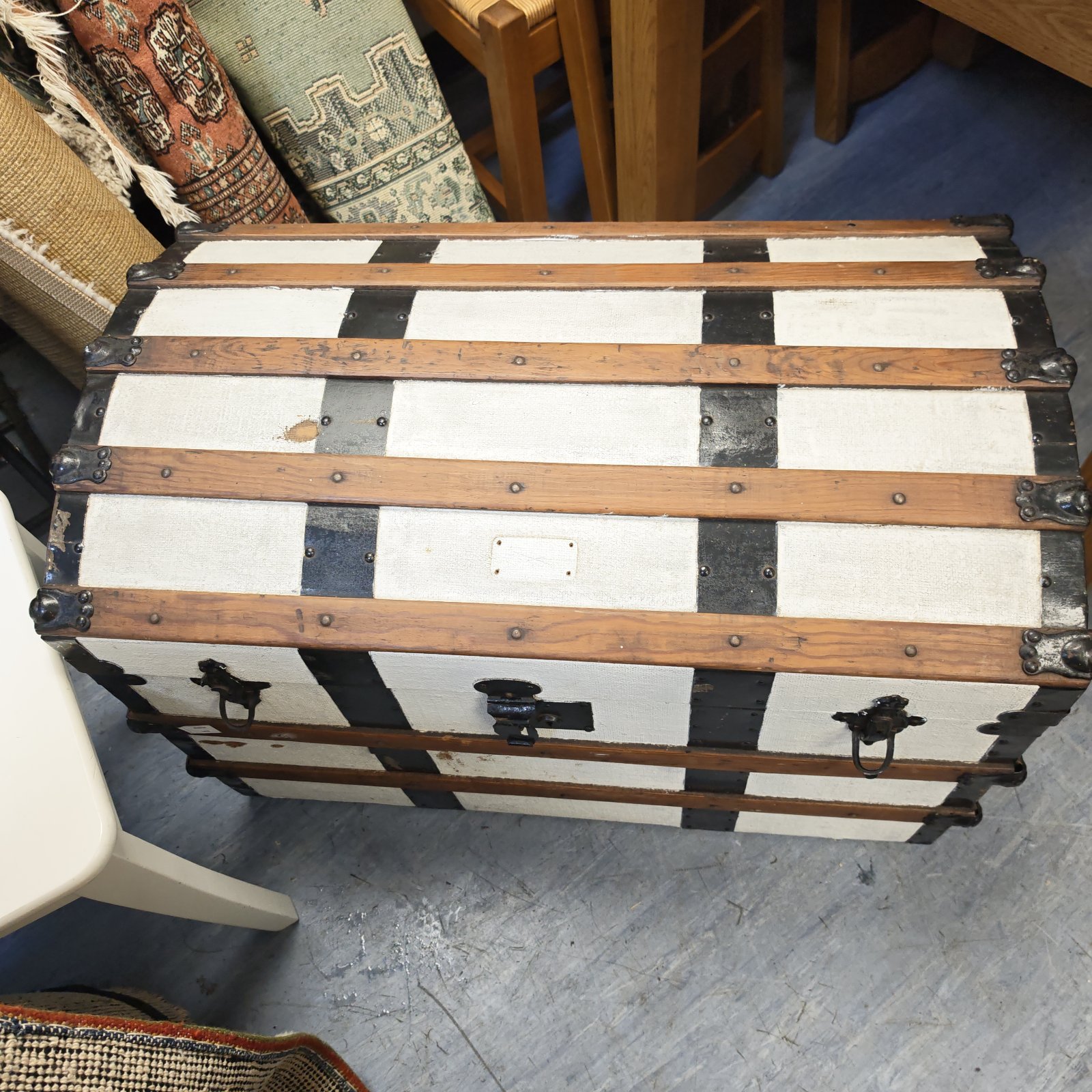 Large white painted wooden trunk with metal hardware.