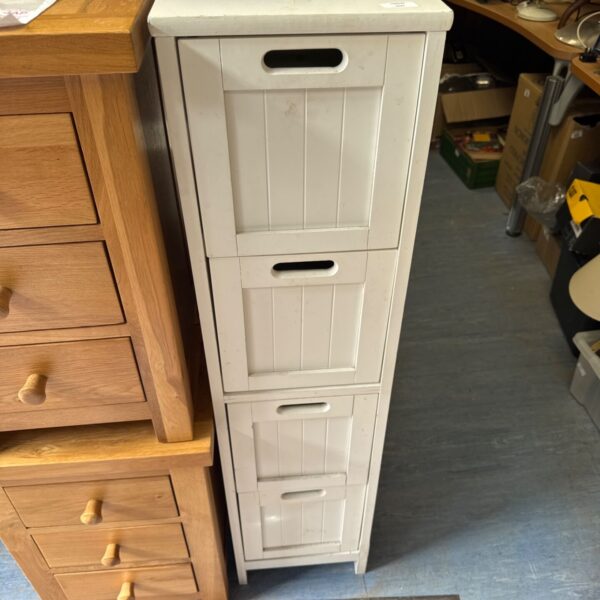White slimline tall boy cabinet with drawers for storage.