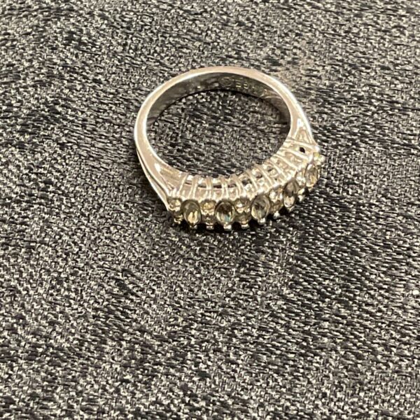 Close-up of a white stone ring in 18k white gold plating.