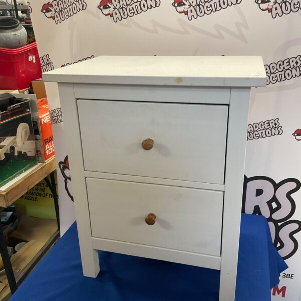 White two-drawer bedside table for bedroom storage.