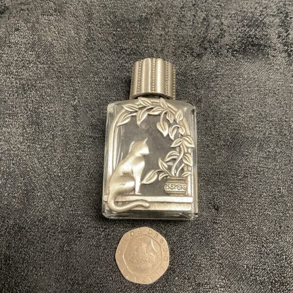 Vintage whitemetal perfume bottle with cat design.