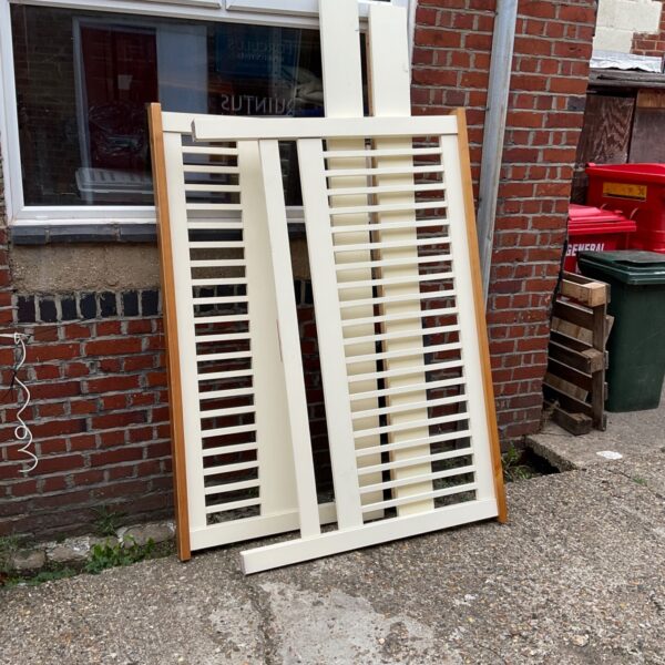 Vintage wooden bedframe headboard with slatted design in cream paint.