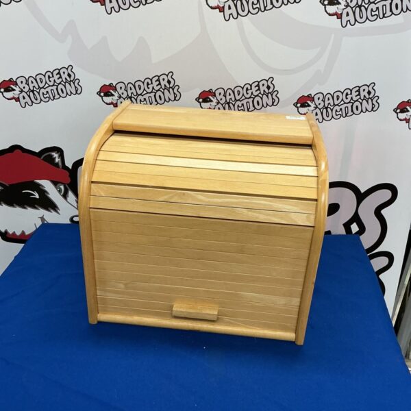 Front view of a wooden bread bin with slatted lid.