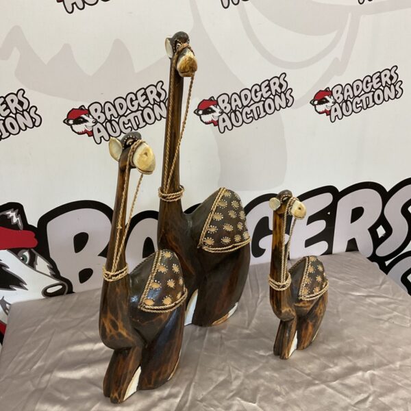 Set of three graduated wooden camels, folk art style.