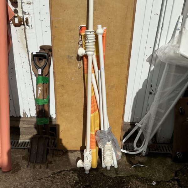 Vintage wooden curtain poles with plastic rings for retro decor.