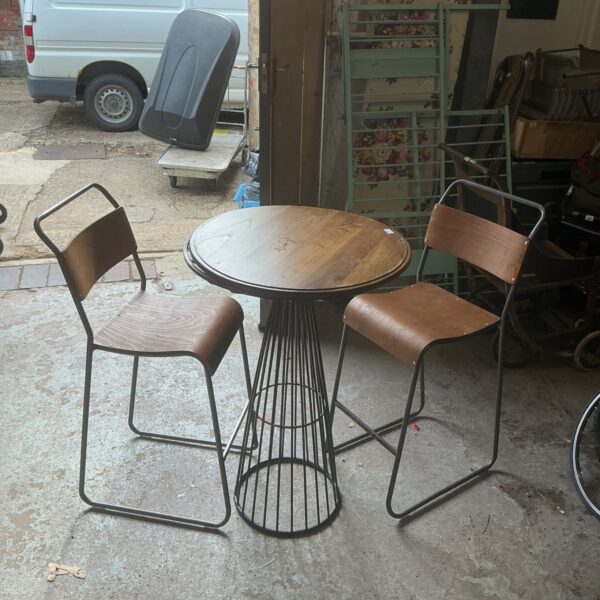 Vintage wooden dining set with metal chairs in a home setting.