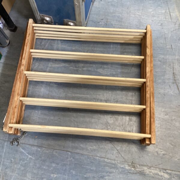 Vintage wooden folding clothes horse for drying laundry indoors.