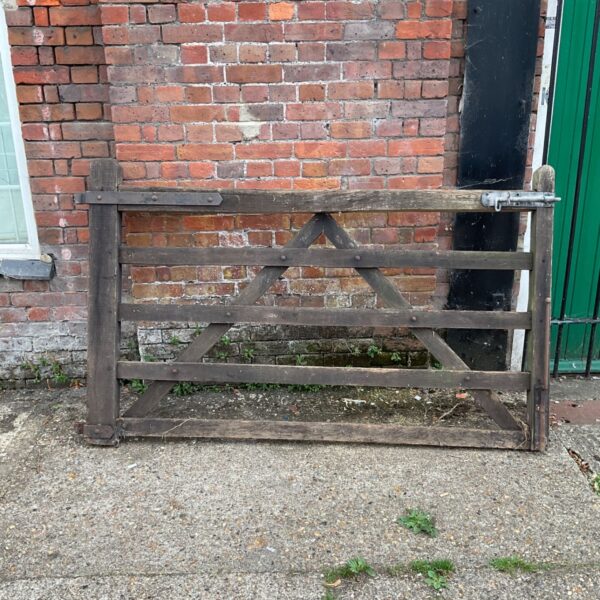 Rustic wooden gate with weathered timber and five-bar design.