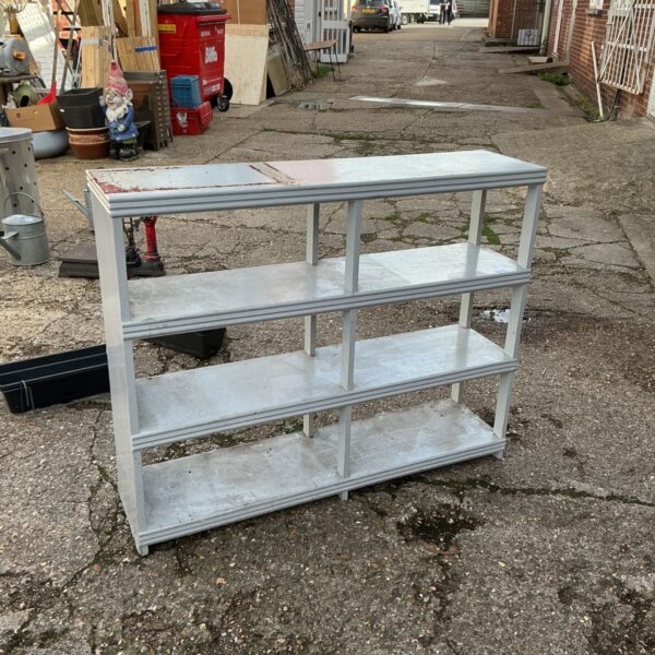 Vintage wooden greenhouse shelf unit for garden storage.