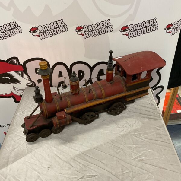 Red vintage wooden model train with metal wheels.