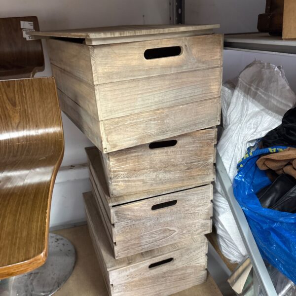 Set of four rustic wooden storage boxes for home organization.