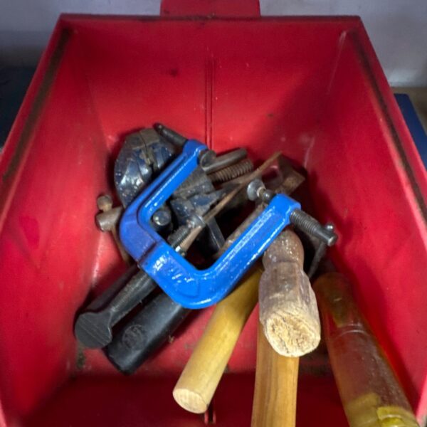 Tray of vintage woodworking tools and clamps for DIY projects.