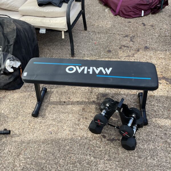 Workout bench with dumbbell set for home fitness training.