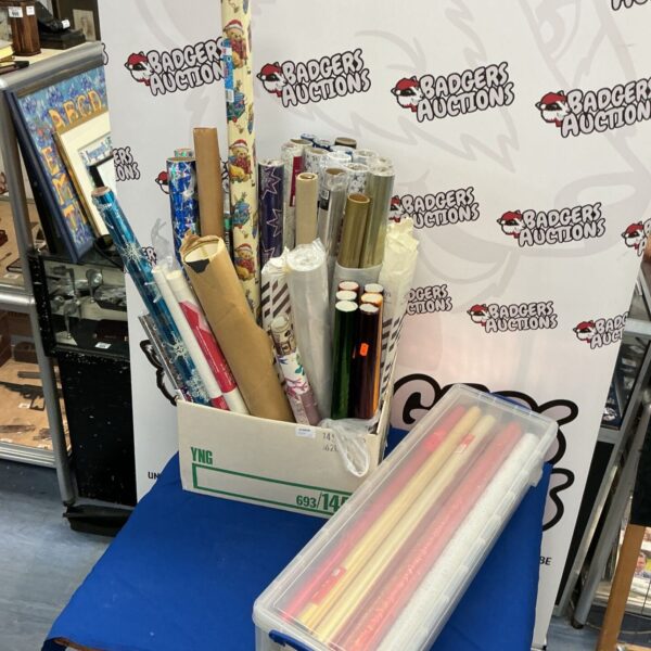 Two boxes filled with colourful wrapping paper rolls.