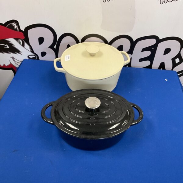 Vintage wrought iron casserole dish with dark enamel finish.