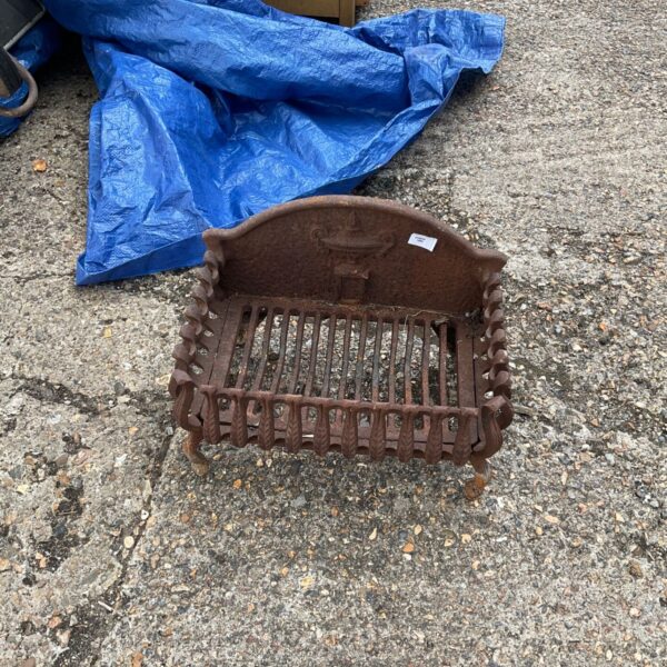 Antique wrought iron fire basket with Victorian detailing for fireplaces.