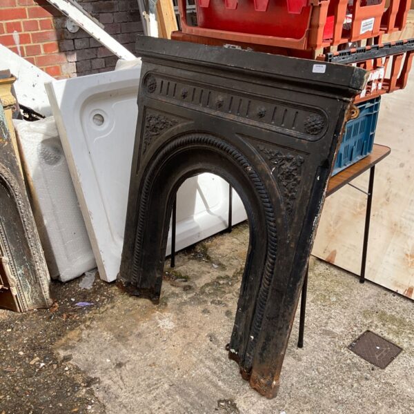 Antique wrought iron fireplace with Victorian detailing.