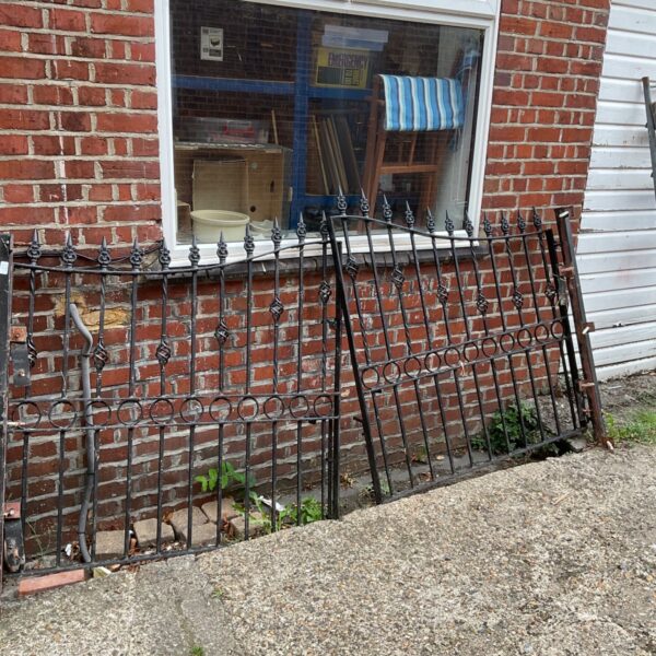 Decorative wrought iron garden gates with curved detailing.