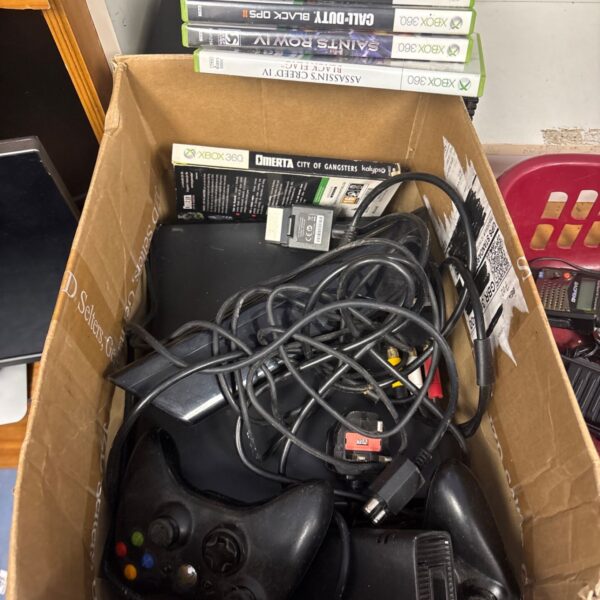 Xbox 360 console with games and Kinect sensor in a box.