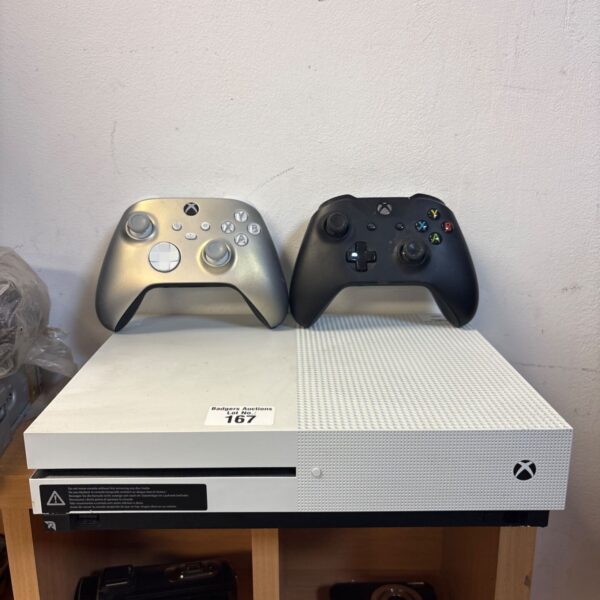 Xbox One X console and two controllers for gaming.