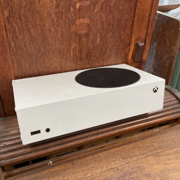 White Xbox Series S digital gaming console on a wooden surface.