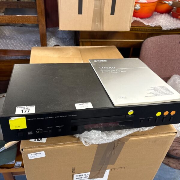 Yamaha CD-S300 compact disc player with manual, vintage audio.