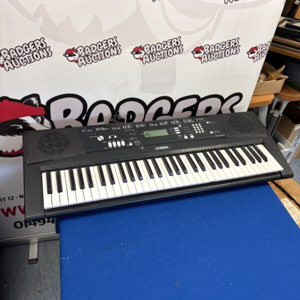 Yamaha EZ-220 digital piano keyboard with keys visible.