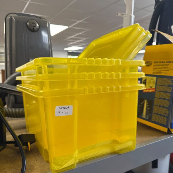 Three yellow plastic storage boxes with lids for household organisation.