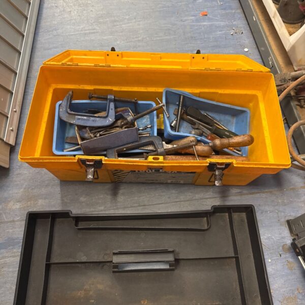 Yellow plastic toolbox filled with various hand tools.