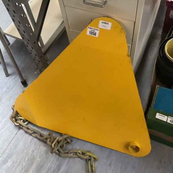 Yellow wheel clamp with chain for vehicle security.