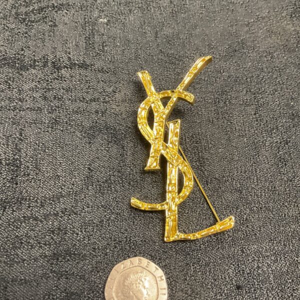 Vintage Yves Saint Laurent gold tone bamboo brooch.