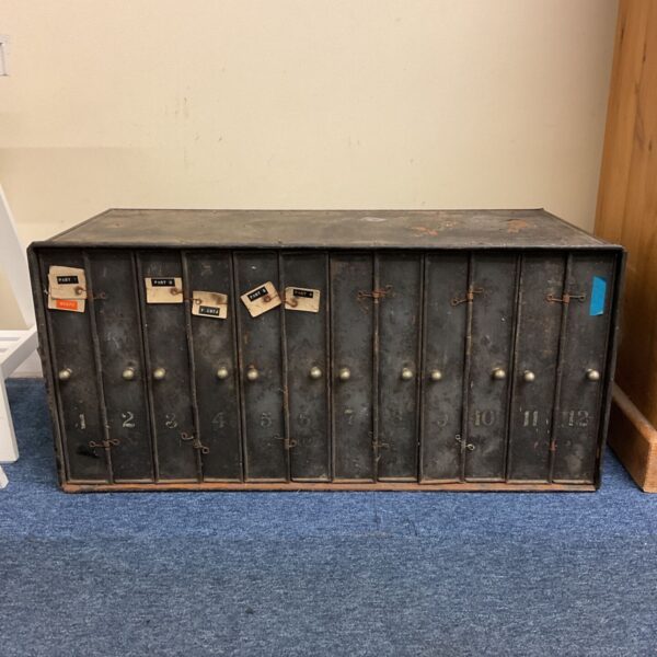 Front view of 1930s metal cinema film reel storage cabinet with numbered doors