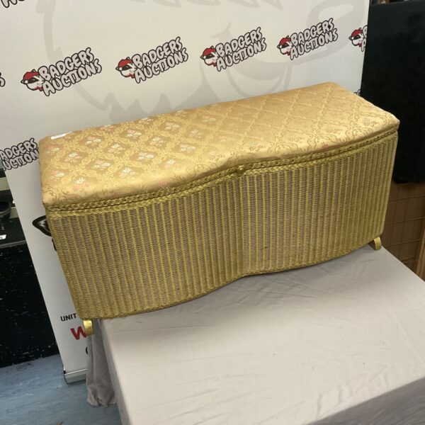 Vintage 1950s gold Lloyd Loom blanket box for bedroom storage.